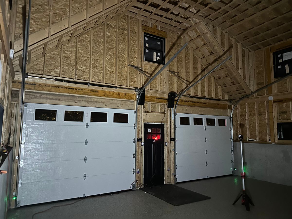 Multi-bay commercial garage doors with work van parked outside in Massachusetts